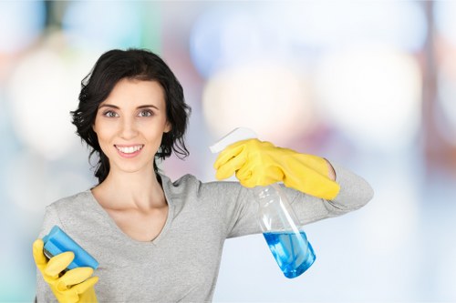 Office cleaning staff sanitizing desks and shared surfaces